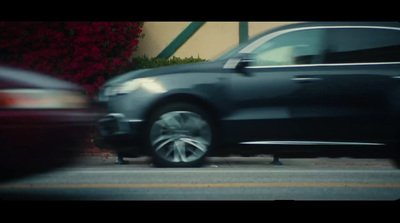 a car driving down a street next to a building