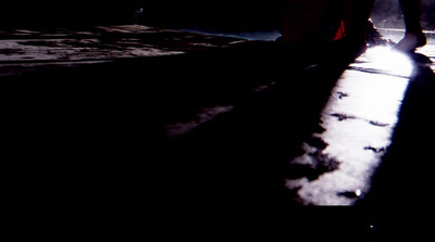 a person walking down a street at night