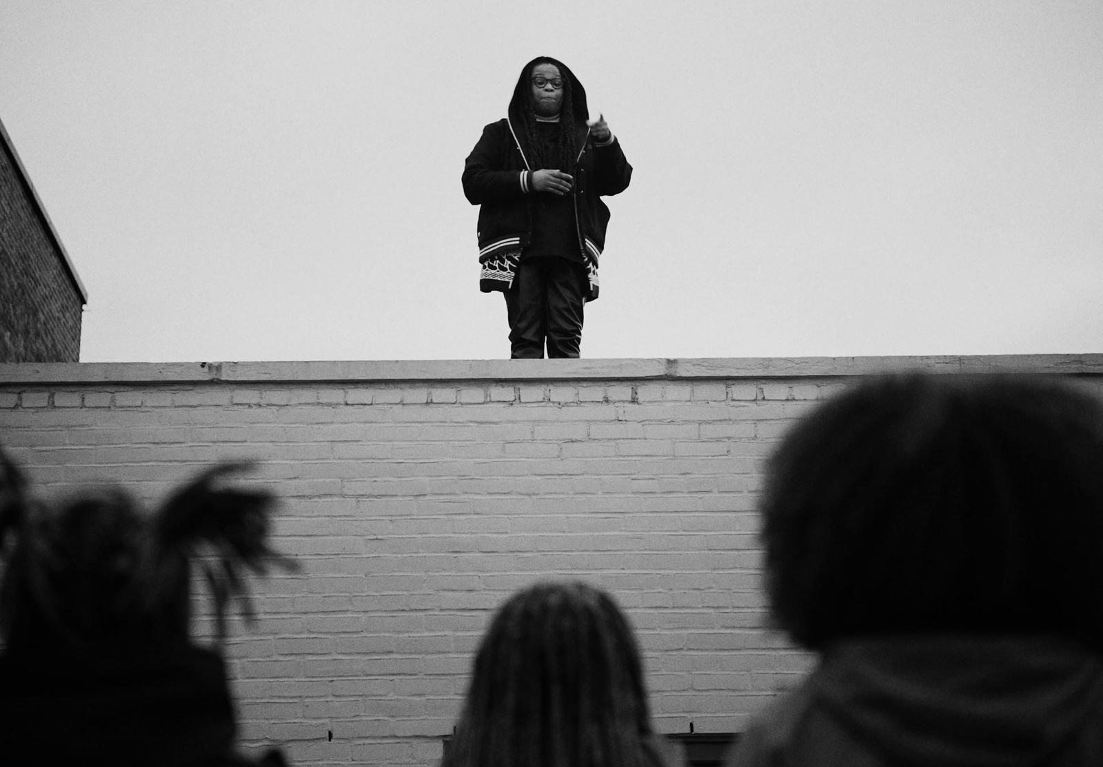 a person standing on top of a brick wall