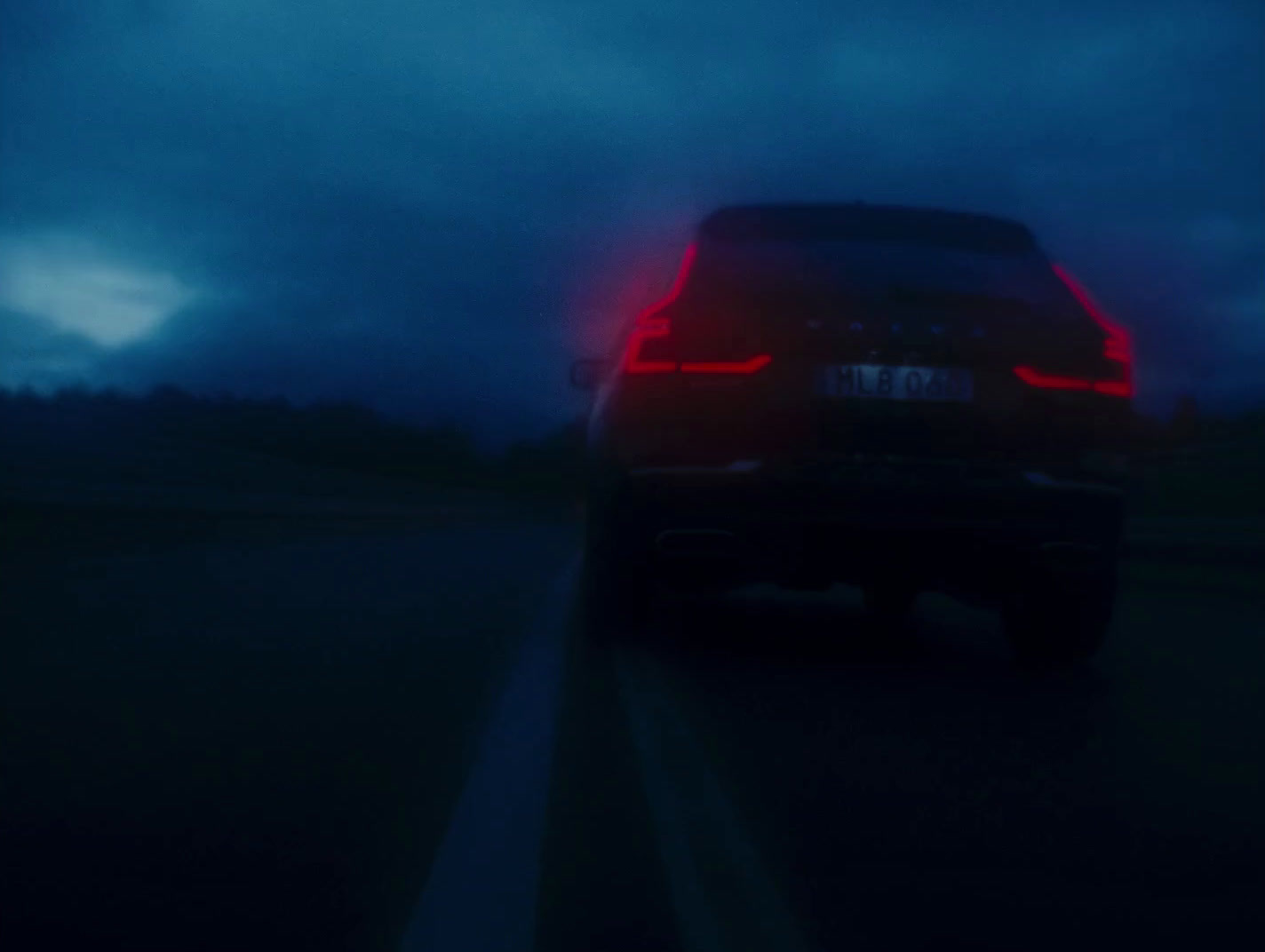 a car driving down a road at night