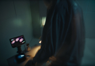 a man standing in front of a tv in a dark room