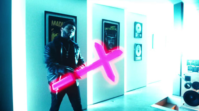 a man holding a neon pink object in a room