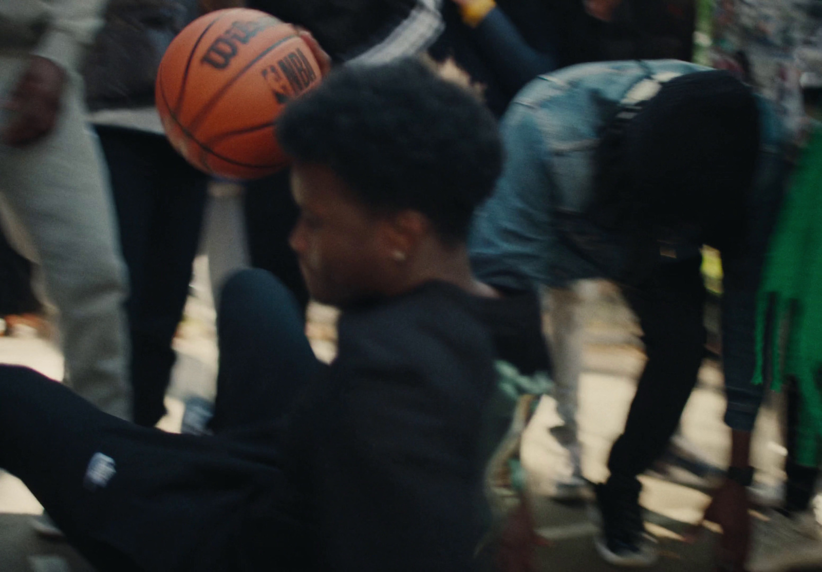 a man sitting on the ground with a basketball in his hand