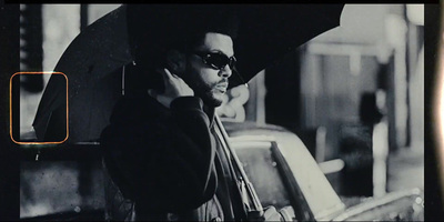 a black and white photo of a man holding an umbrella