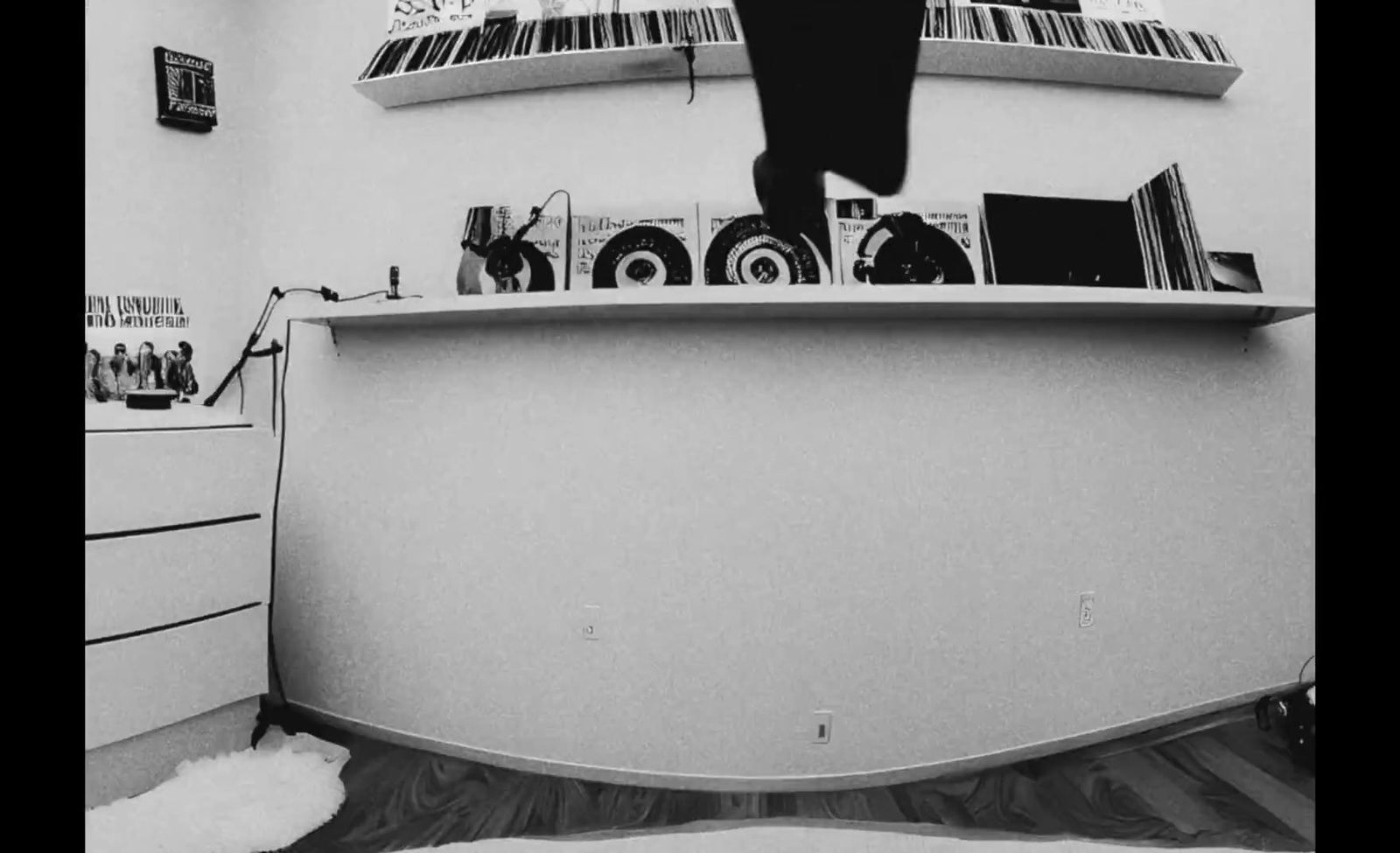 a black and white photo of a person standing on a counter