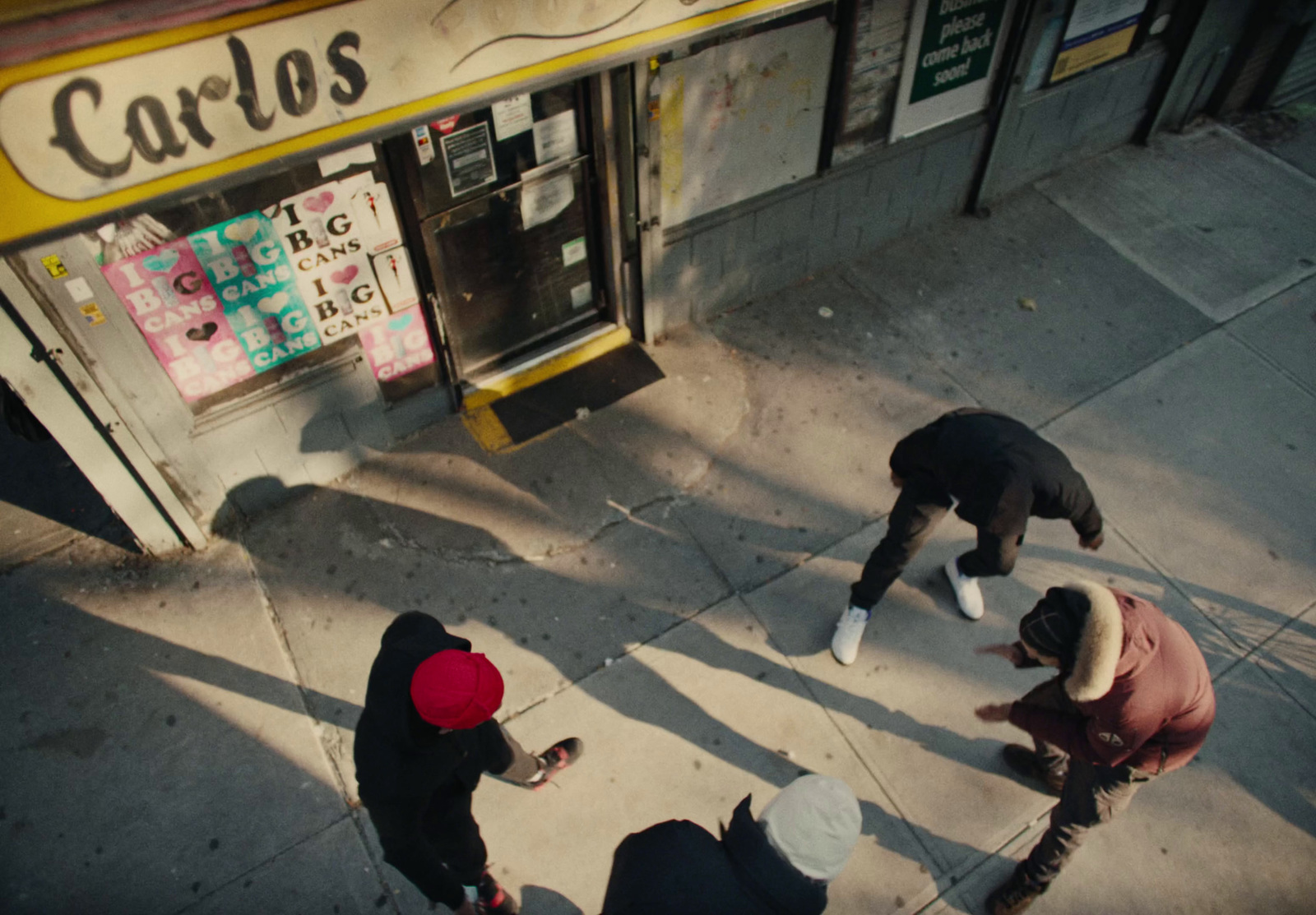 a group of people standing outside of a store