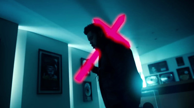 a man standing in a room with a neon cross on his chest