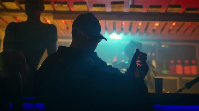 a man holding a cell phone in a dark room