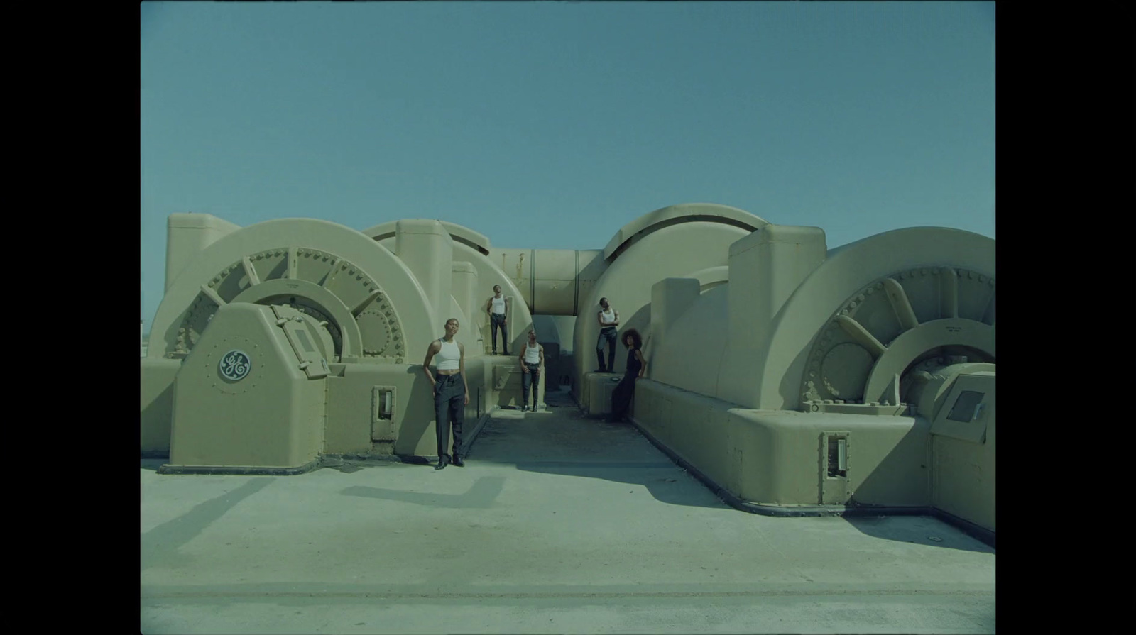 a group of people standing in front of a large machine