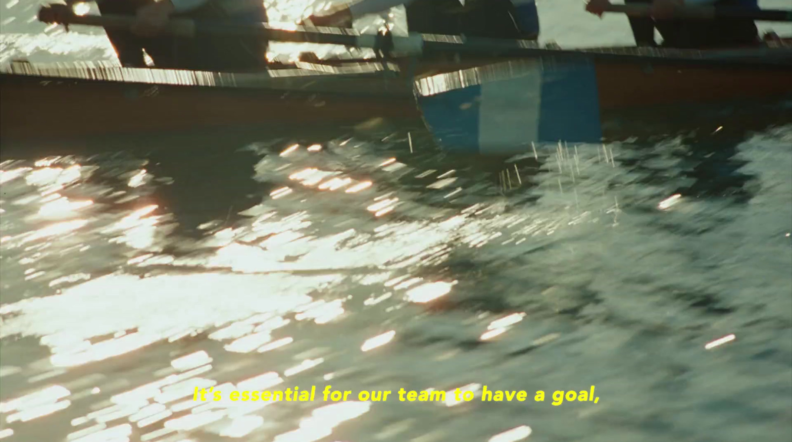 a group of people rowing a boat in the water