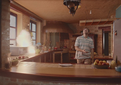 a man standing in a kitchen next to a counter