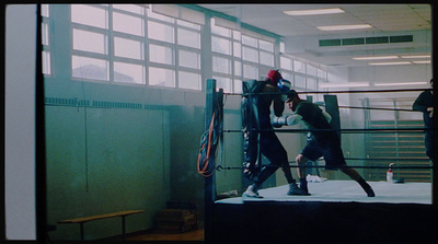 a couple of men standing next to each other in a boxing ring