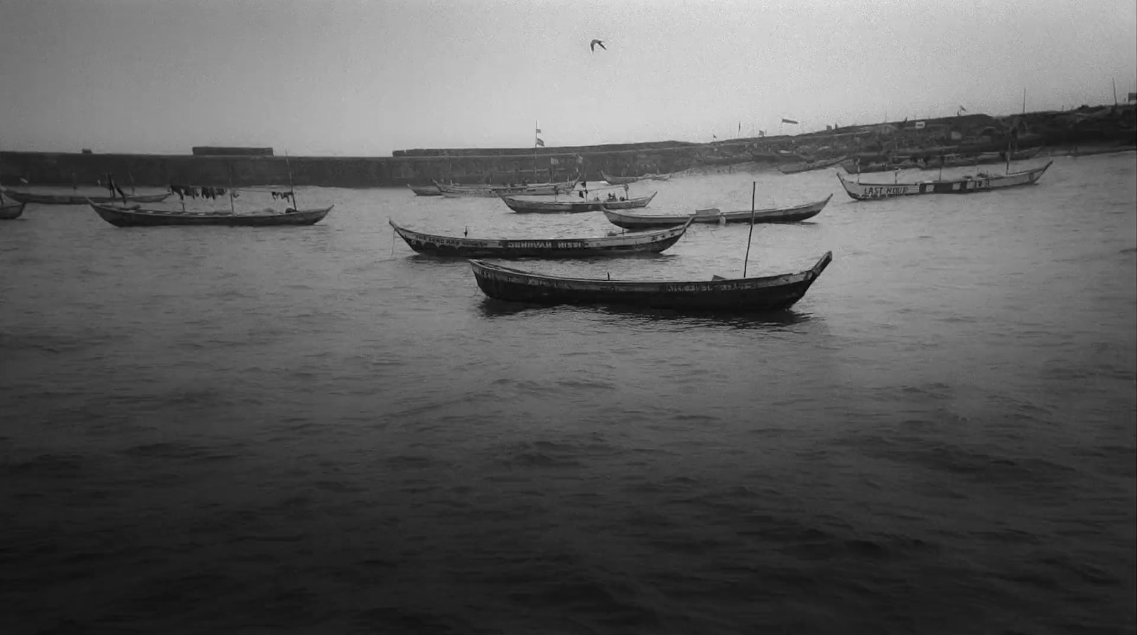 a group of boats floating on top of a body of water