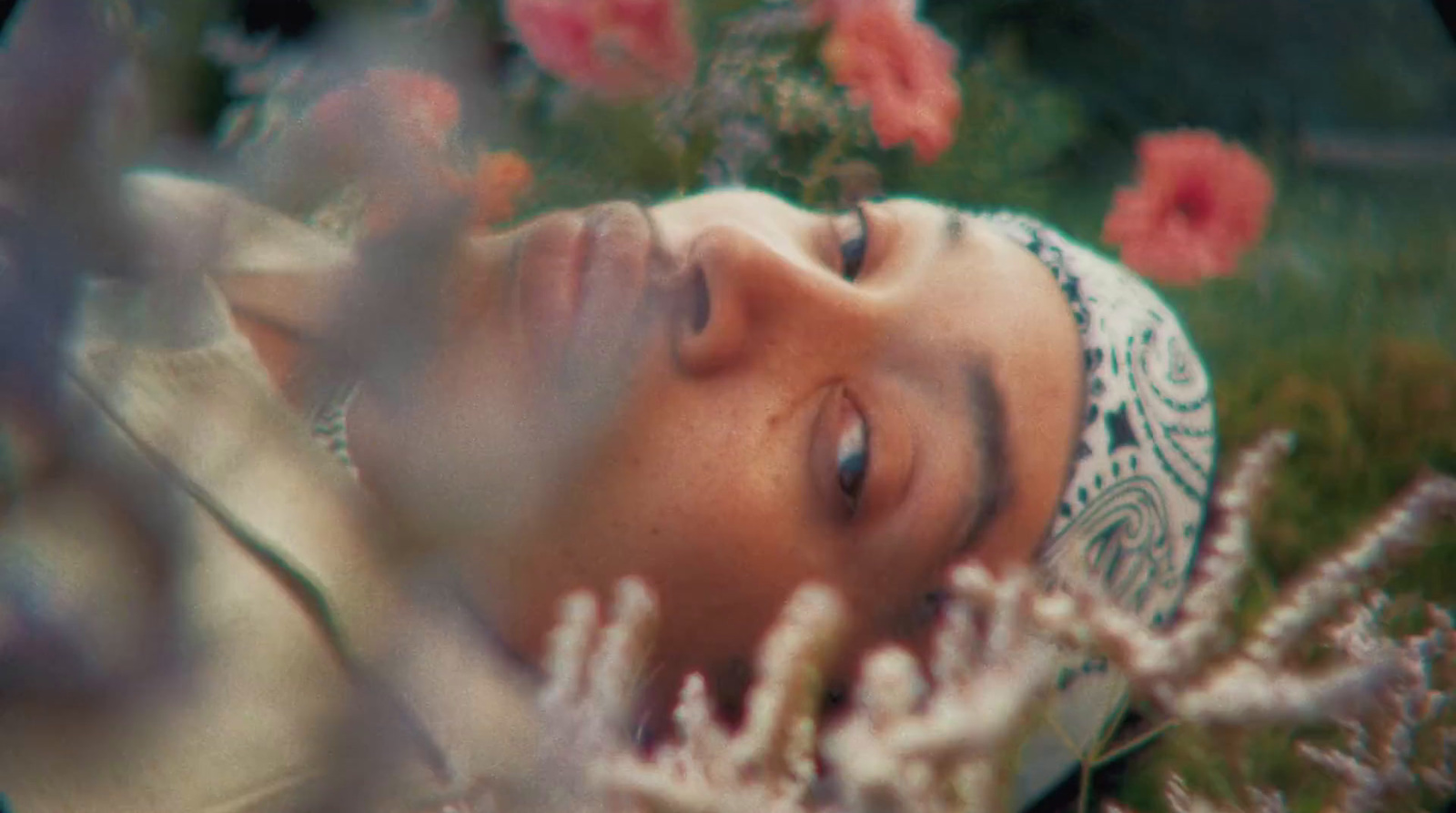 a woman laying down in a field of flowers