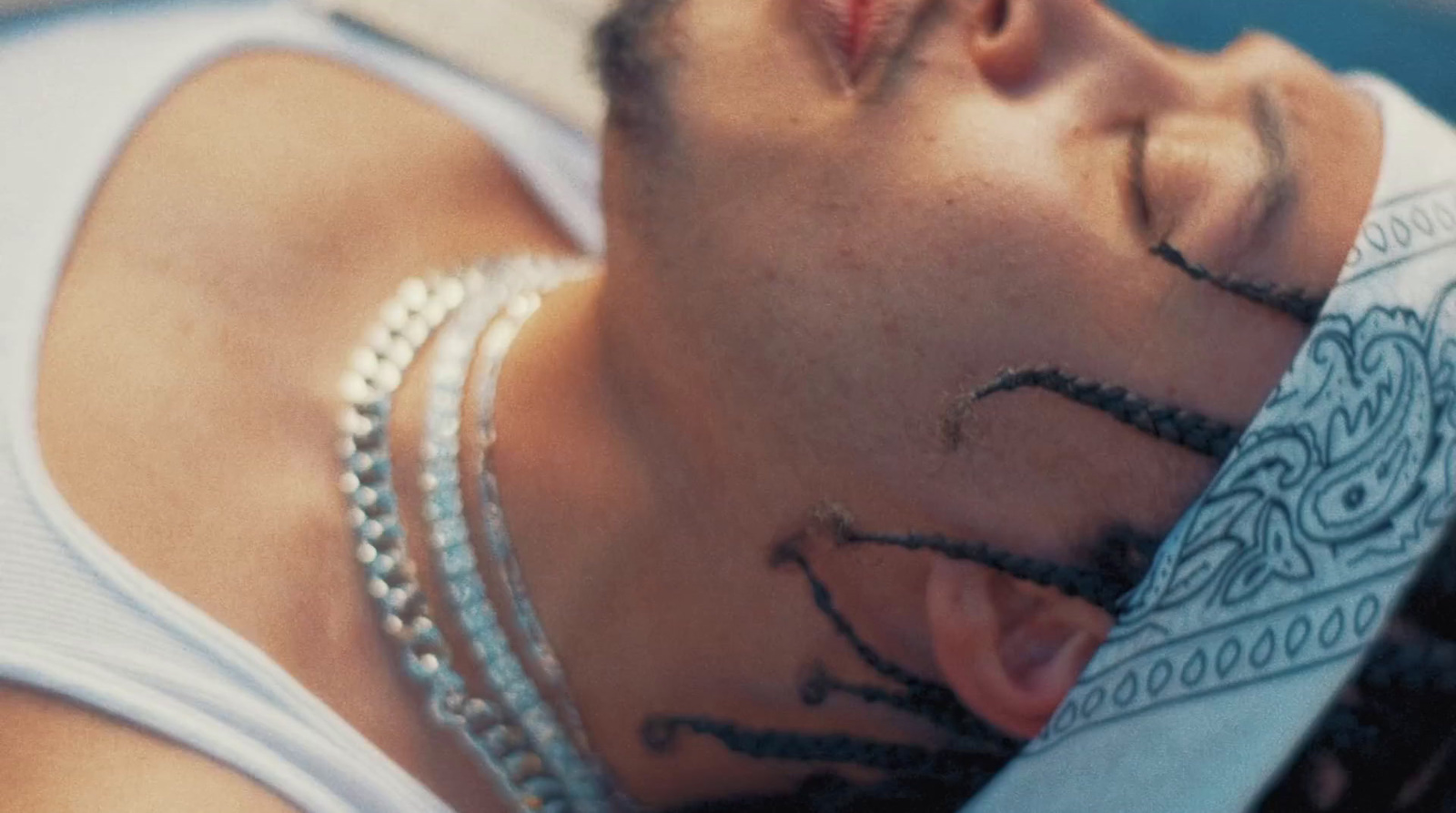 a man with tattoos on his face sleeping