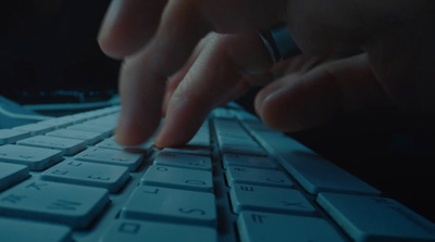 a close up of a person typing on a keyboard