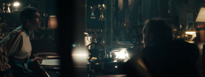 a man and a woman sitting at a table in a dark room