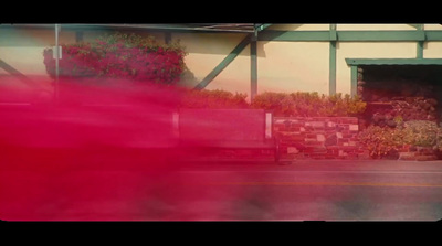 a blurry photo of a red truck parked in front of a building