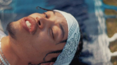 a man with a bandana on laying down