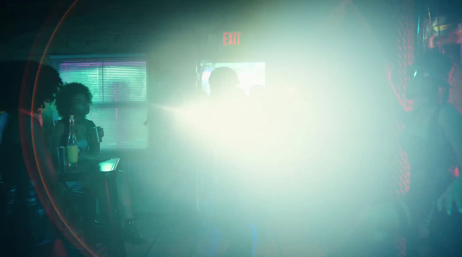 a group of people standing around in a dark room