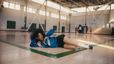 a woman laying on the floor in a gym