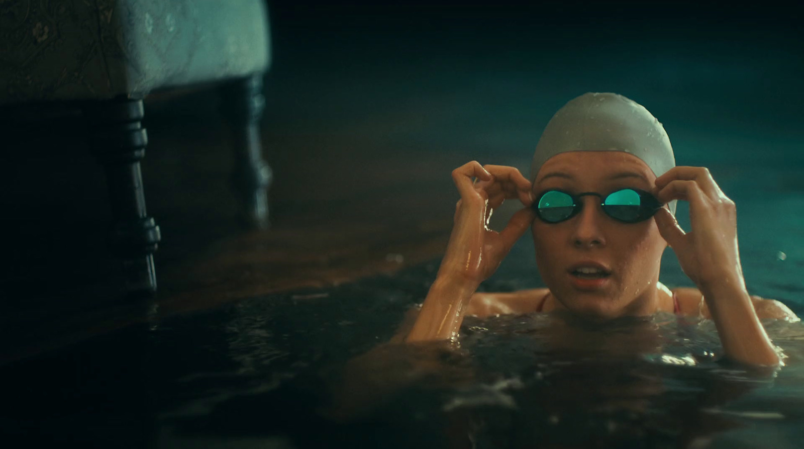 a woman in a swimming pool wearing goggles