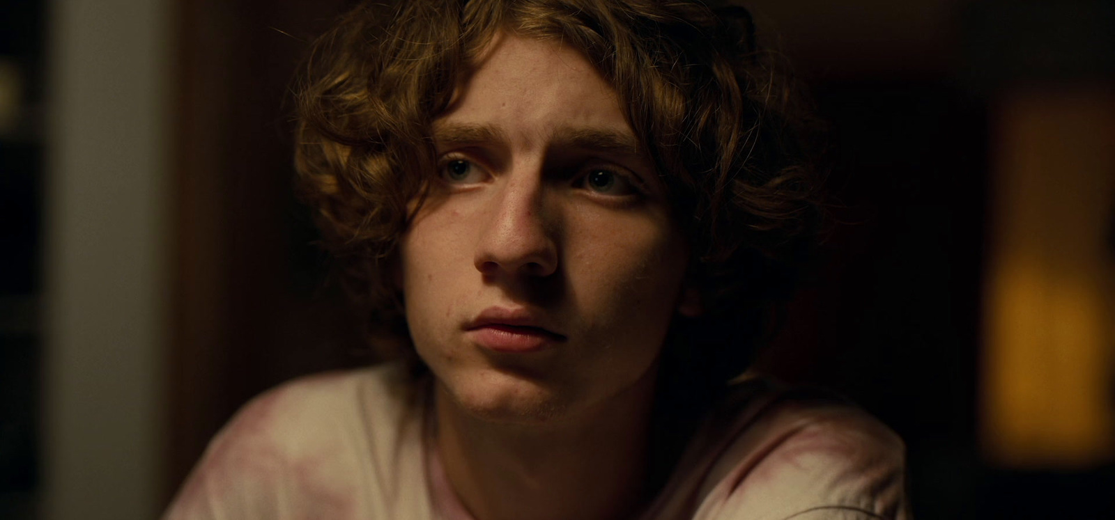 a close up of a person with curly hair