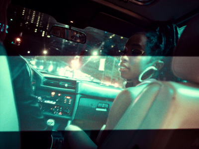 a woman driving a car at night time