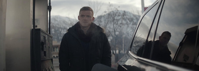 a man standing next to a van in the snow