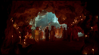 a group of people standing inside of a cave