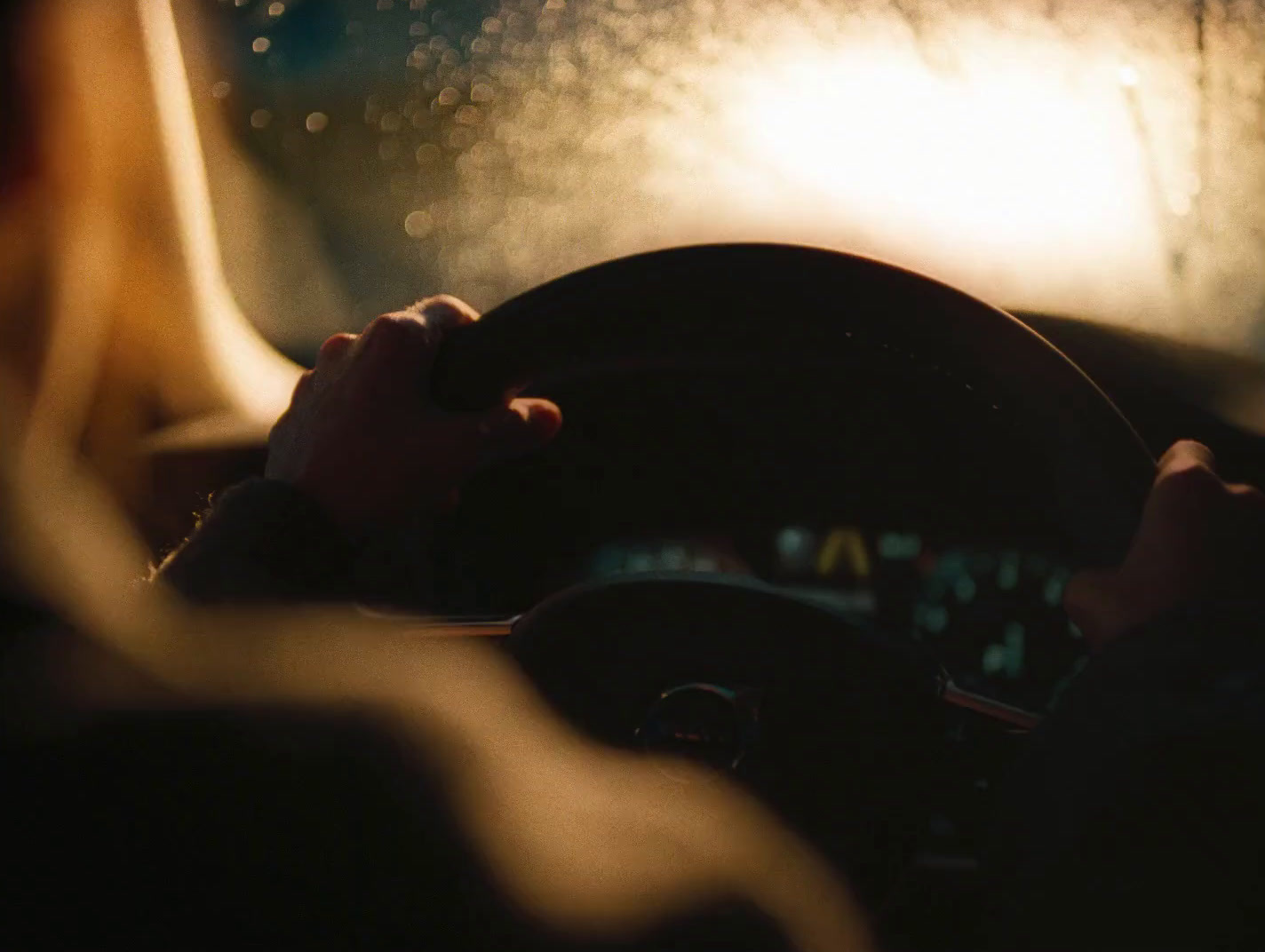 a person driving a car in the dark