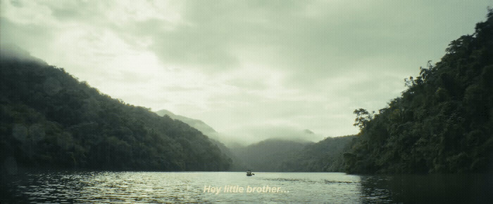 a body of water surrounded by mountains under a cloudy sky