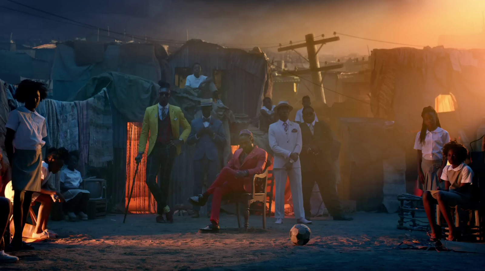 a group of people standing around a soccer ball