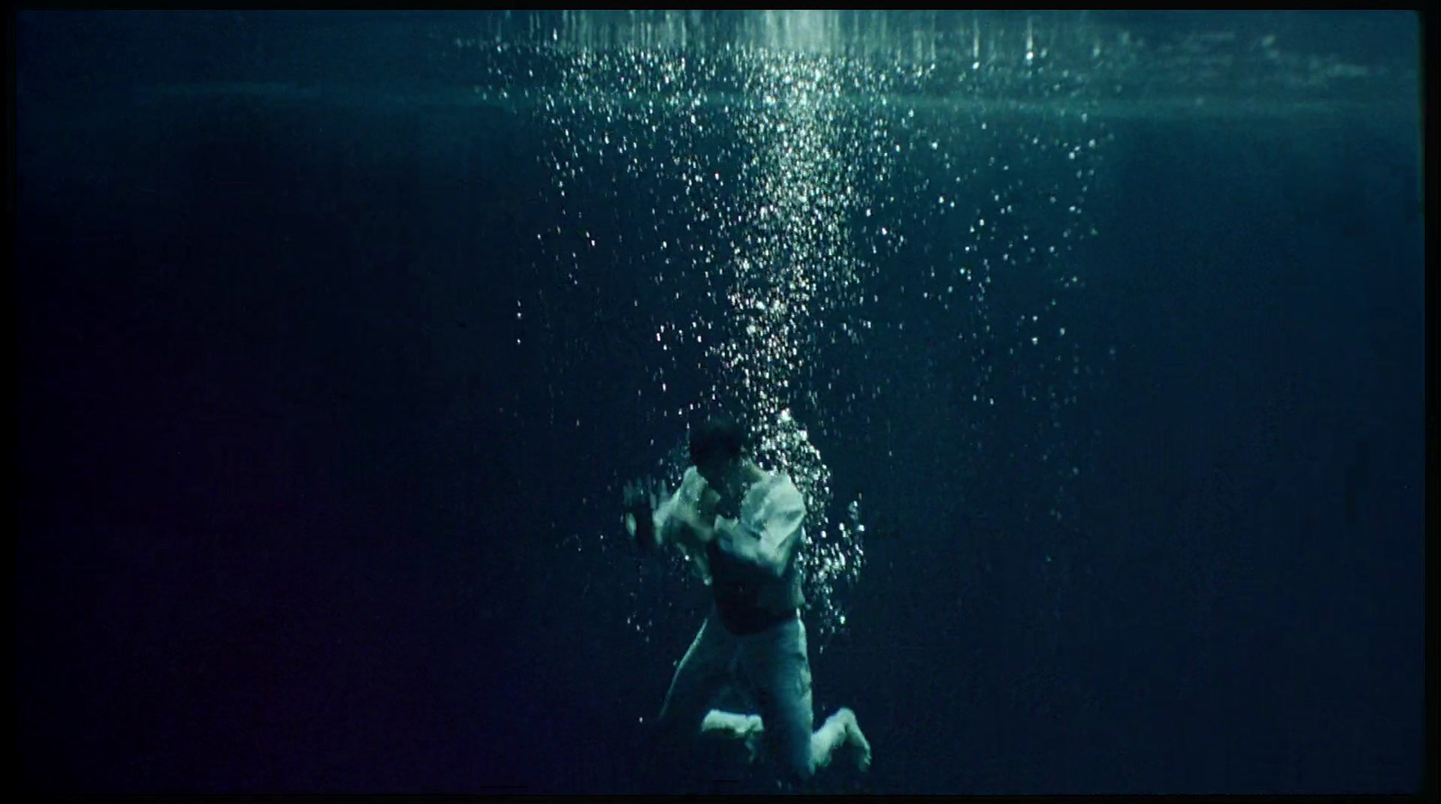 a man swimming under water in the ocean