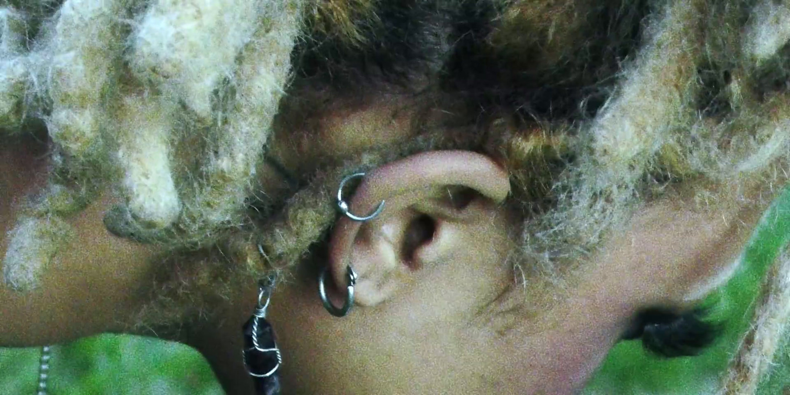 a close up of a person with dread locks