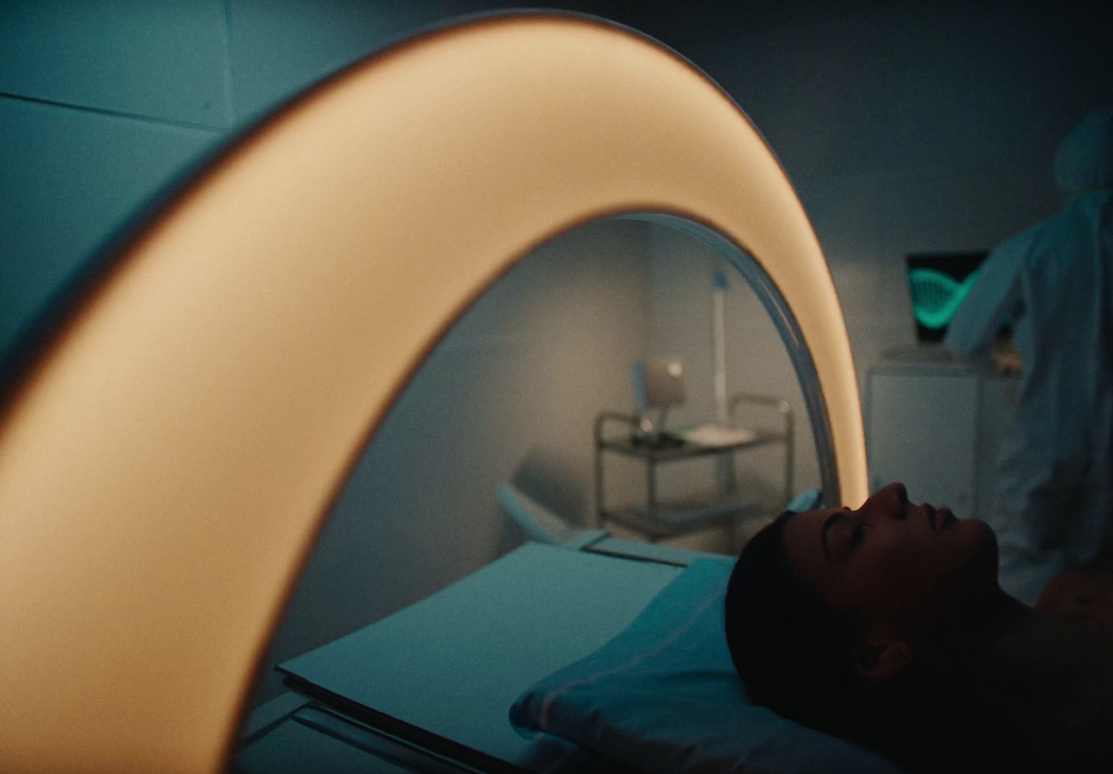 a person laying in a hospital bed with a light on