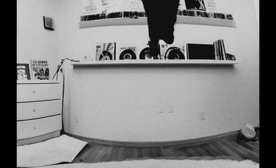 a black and white photo of a person jumping on a desk