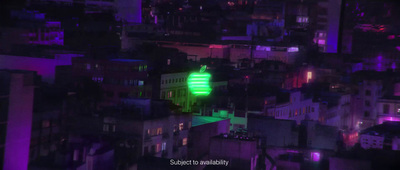 a green light on top of a tall building