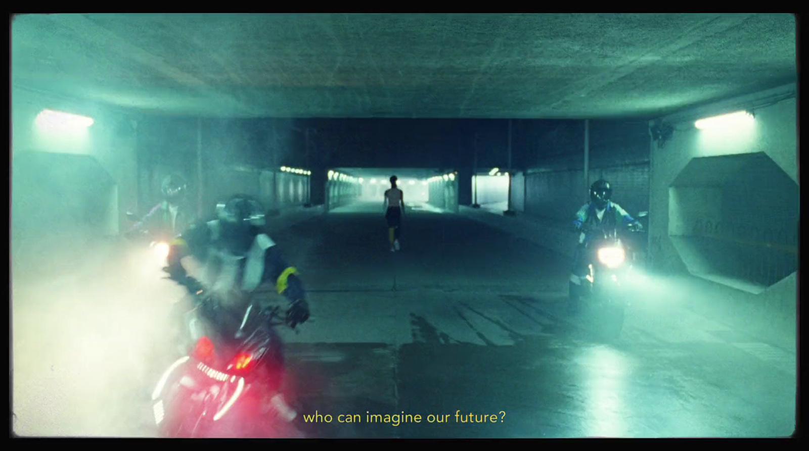 a group of people riding motorcycles through a tunnel