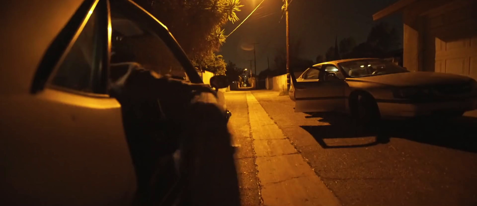 a car parked on the side of a street at night