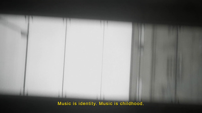 a black and white photo of a window with the words music is identity music is