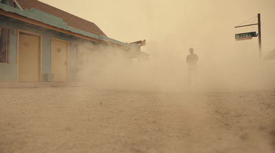 a man standing in the middle of a dust storm