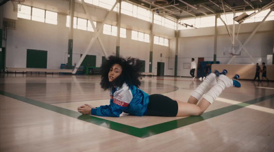 a woman laying on the floor in a gym