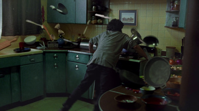 a man standing in a kitchen preparing food