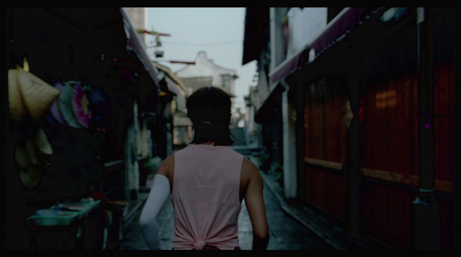 a person walking down a narrow alley way