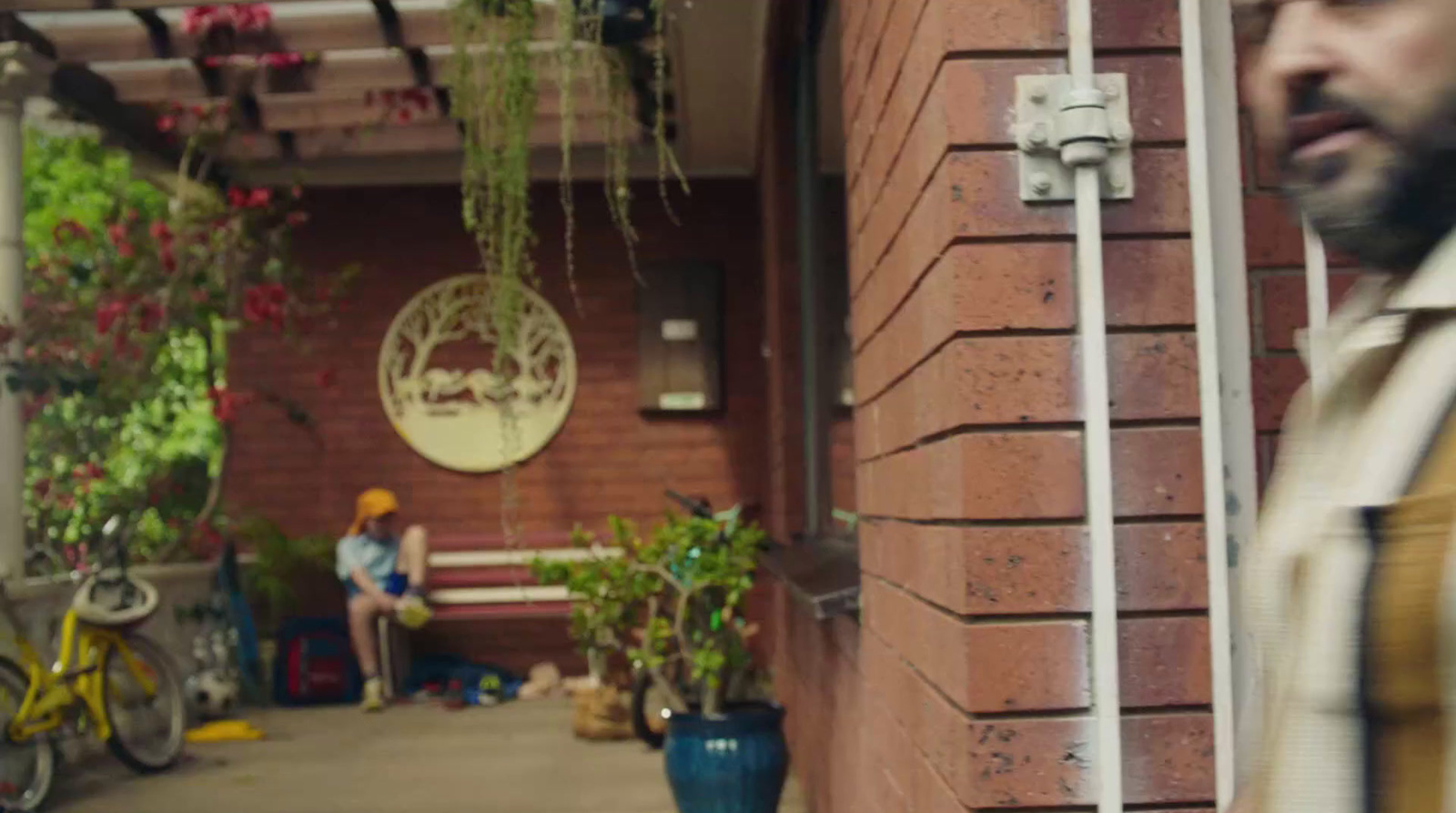 a man standing next to a brick building