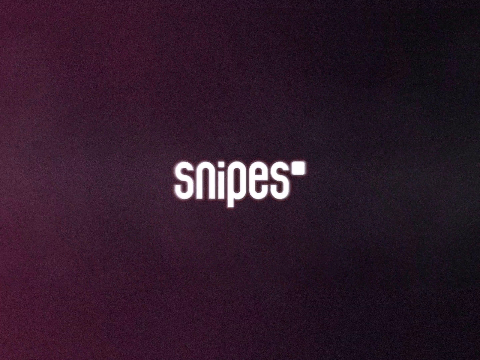 a close up of the word snipes on a purple background