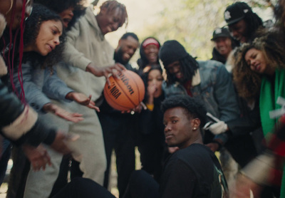 a group of people standing around a basketball