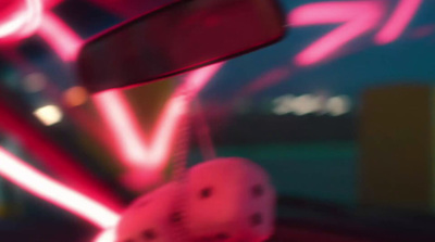 a close up of a car mirror with neon lights in the background