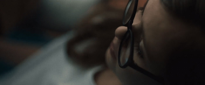 a close up of a person wearing glasses